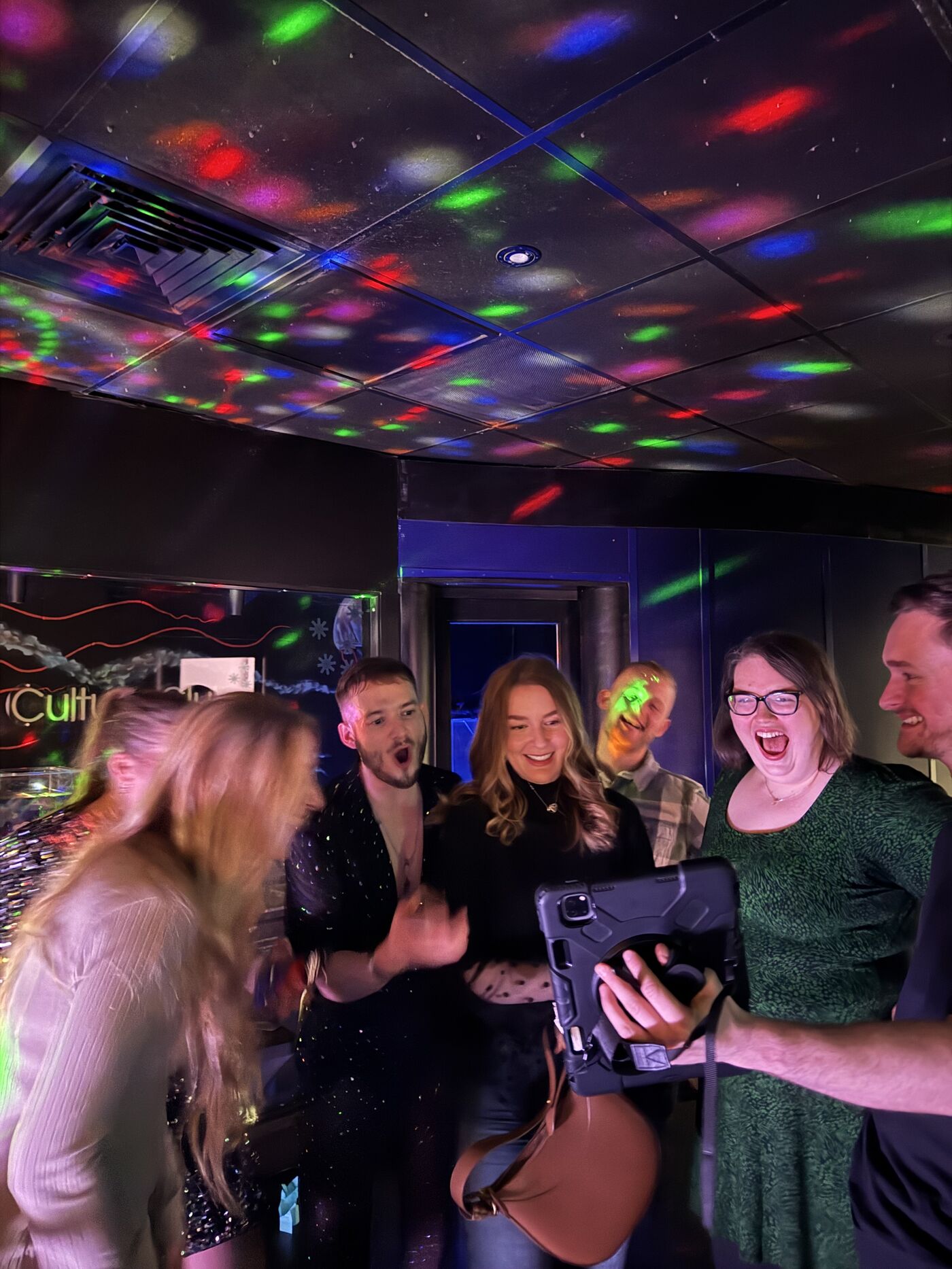 Guests laughing as they watch their 360 video back at the Party Octopus sharing station
